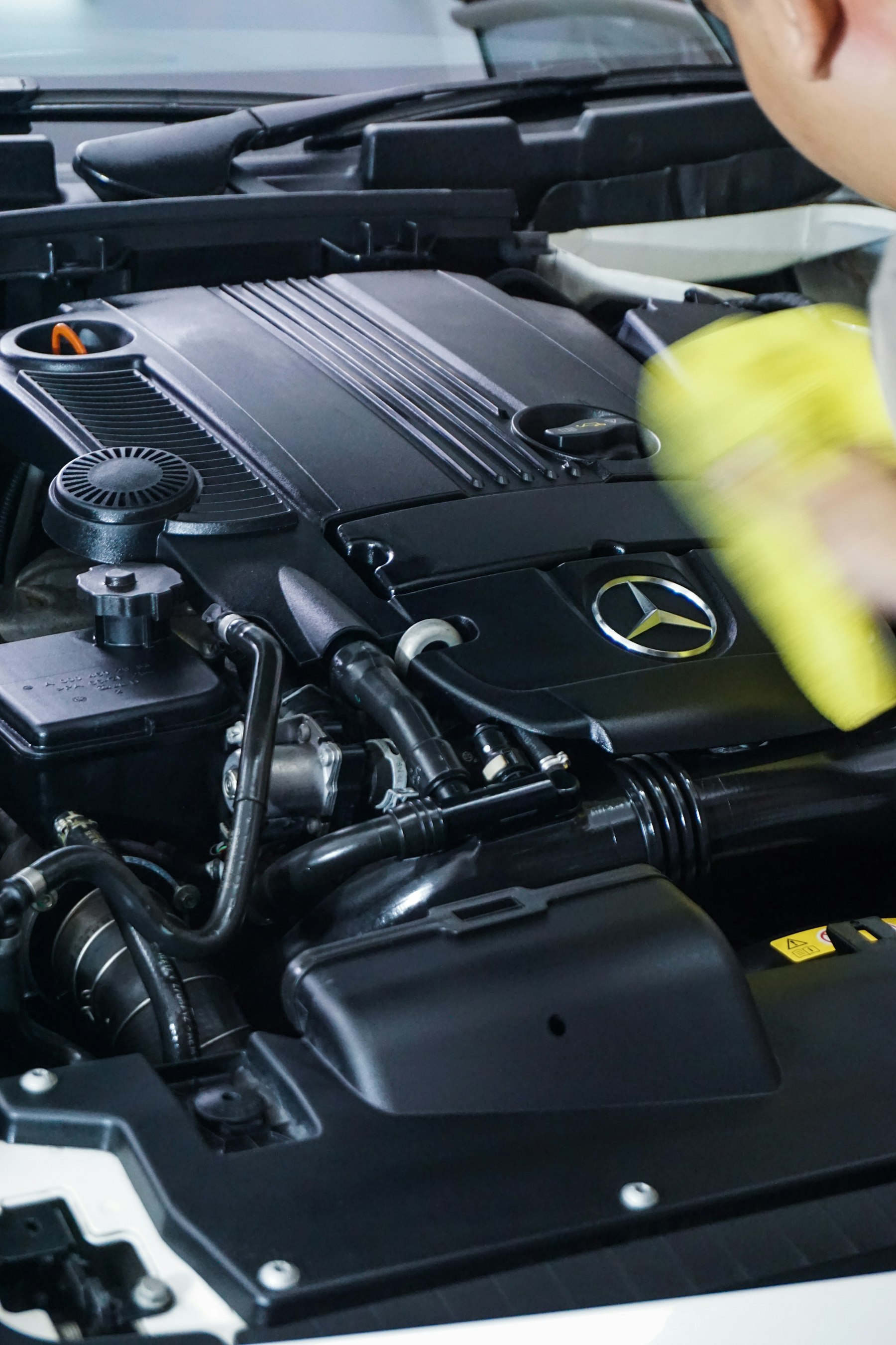 Engine bay detailing — Mercedes engine being cleaned